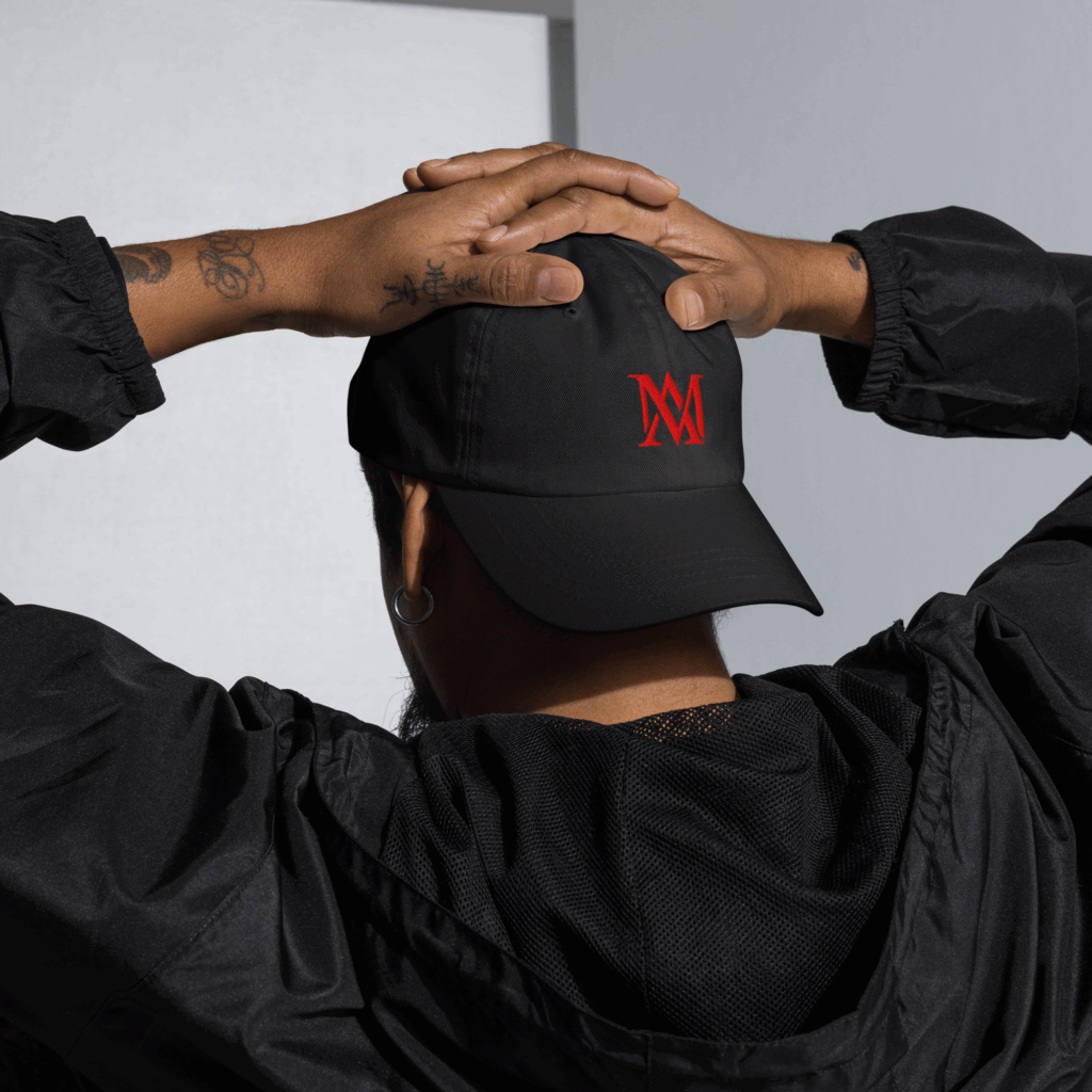 Person wearing black cap with red logo