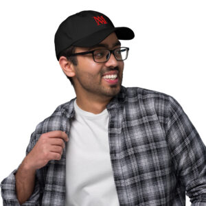 Smiling man in cap, glasses, plaid shirt