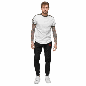 Tattooed man wearing white t-shirt and black pants