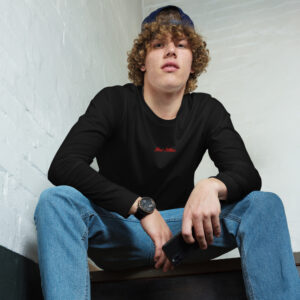 Curly-haired young man sitting, holding phone