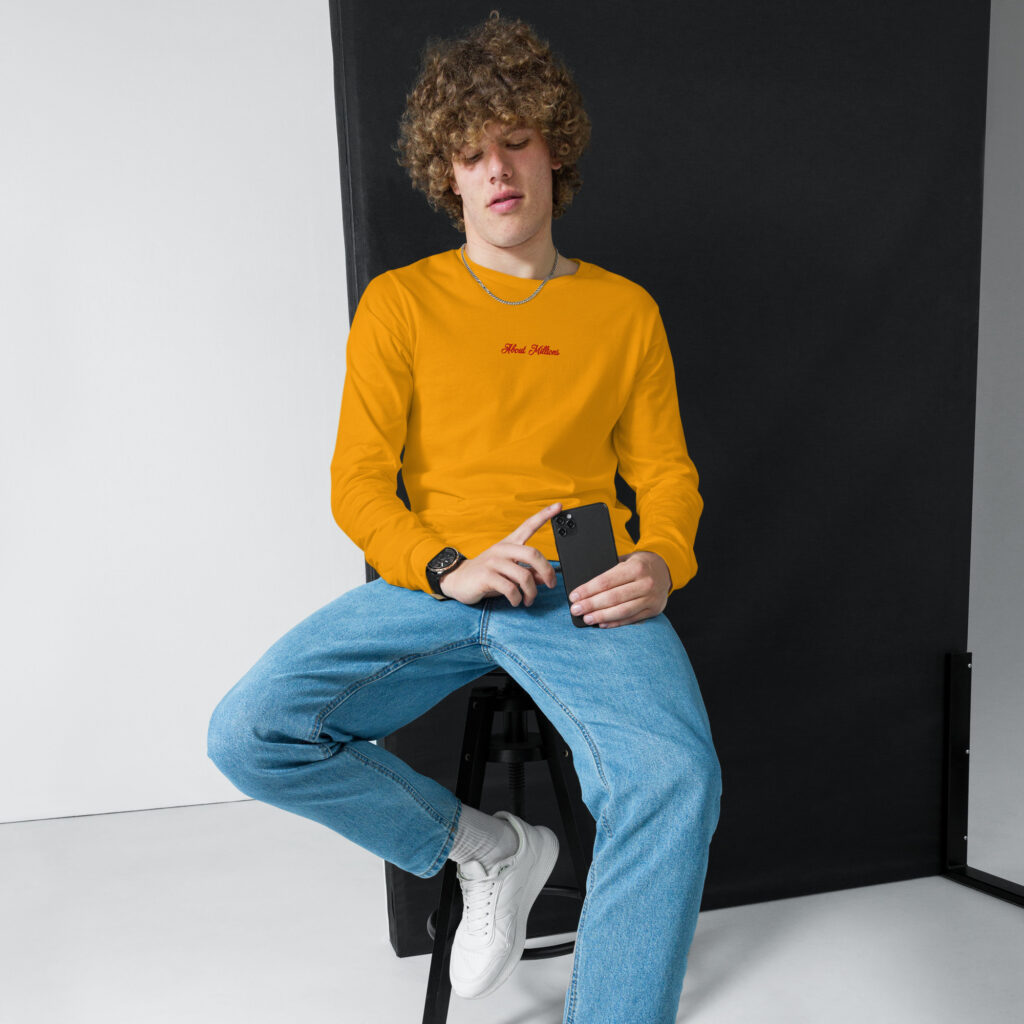 Young man in orange sweatshirt holding phone