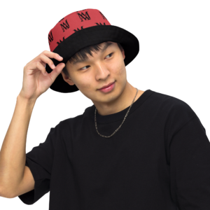 Person adjusting red and black bucket hat