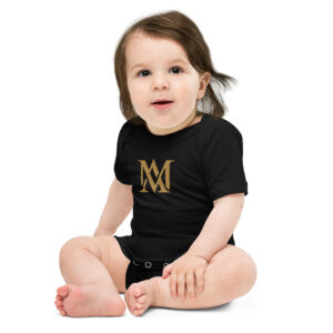 Baby in black onesie with gold logo