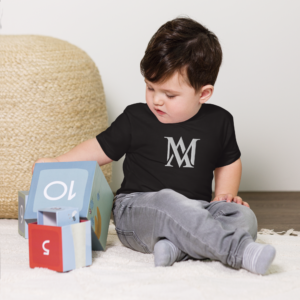 Toddler sitting on floor playing with blocks