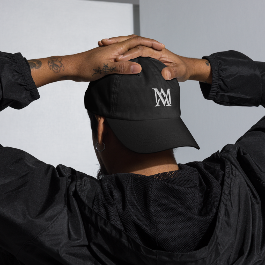 Rear view of person wearing black logo cap