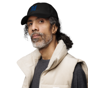 Bearded man wearing black cap and beige vest