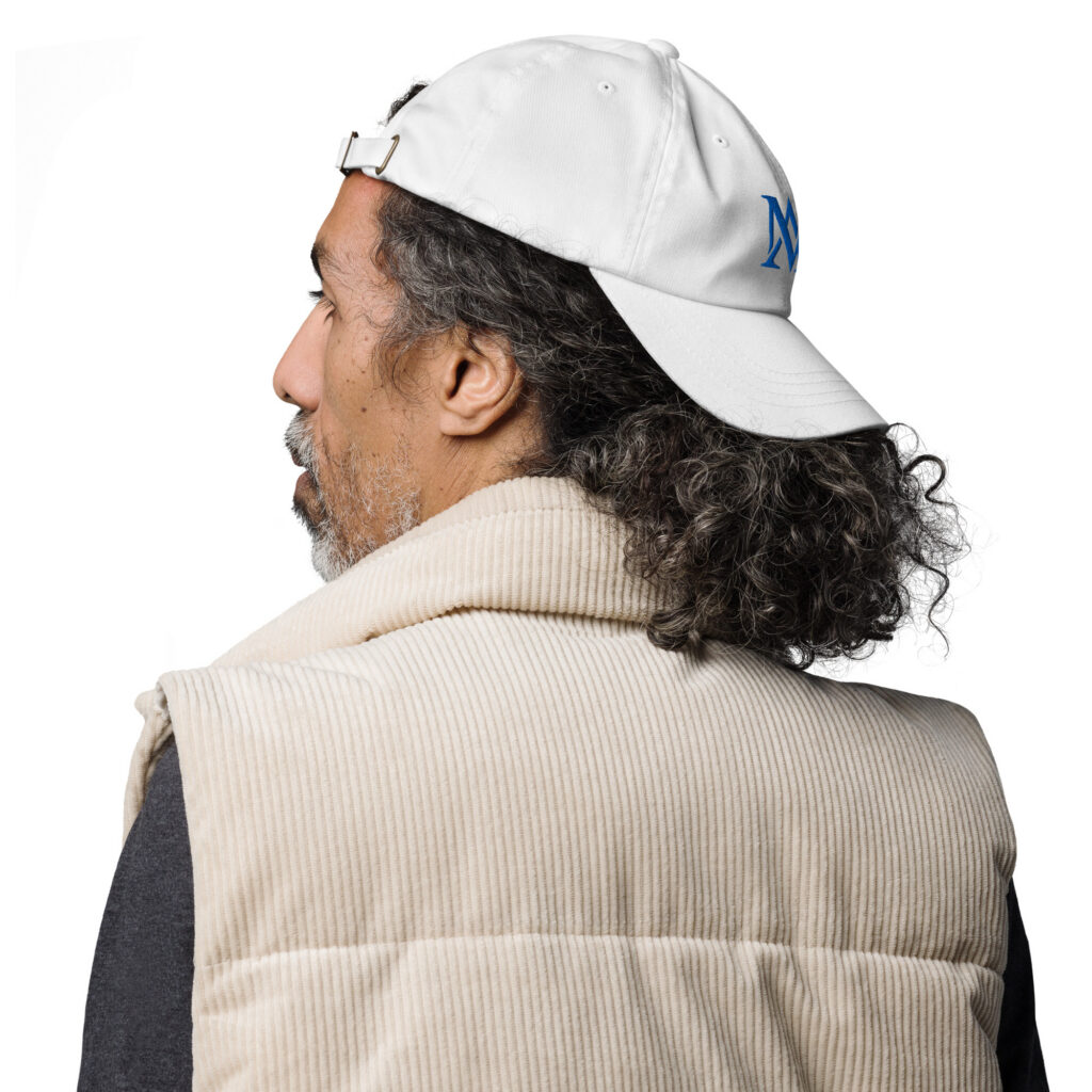 Man in beige vest wearing backward white cap
