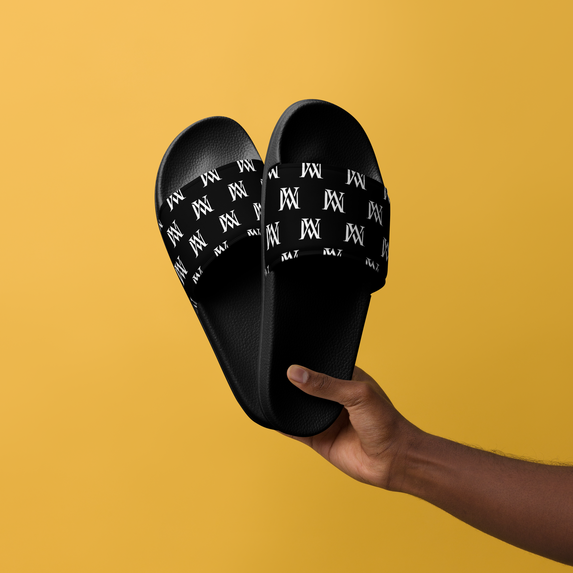 Hand holding black logo slides on yellow