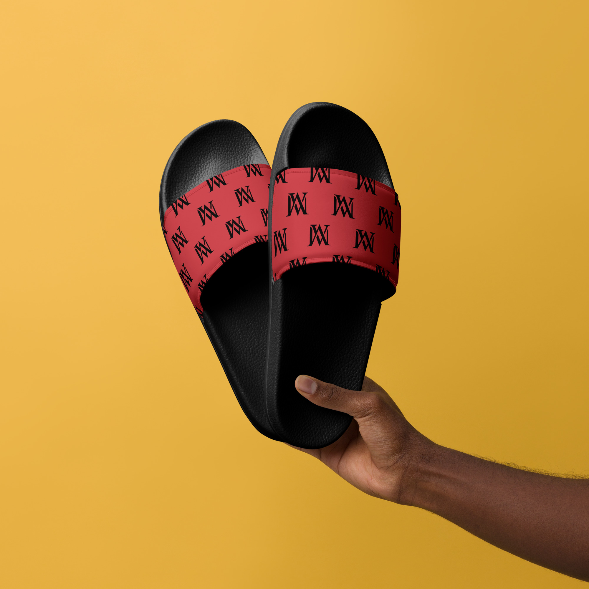 Hand holding black and red slides on yellow