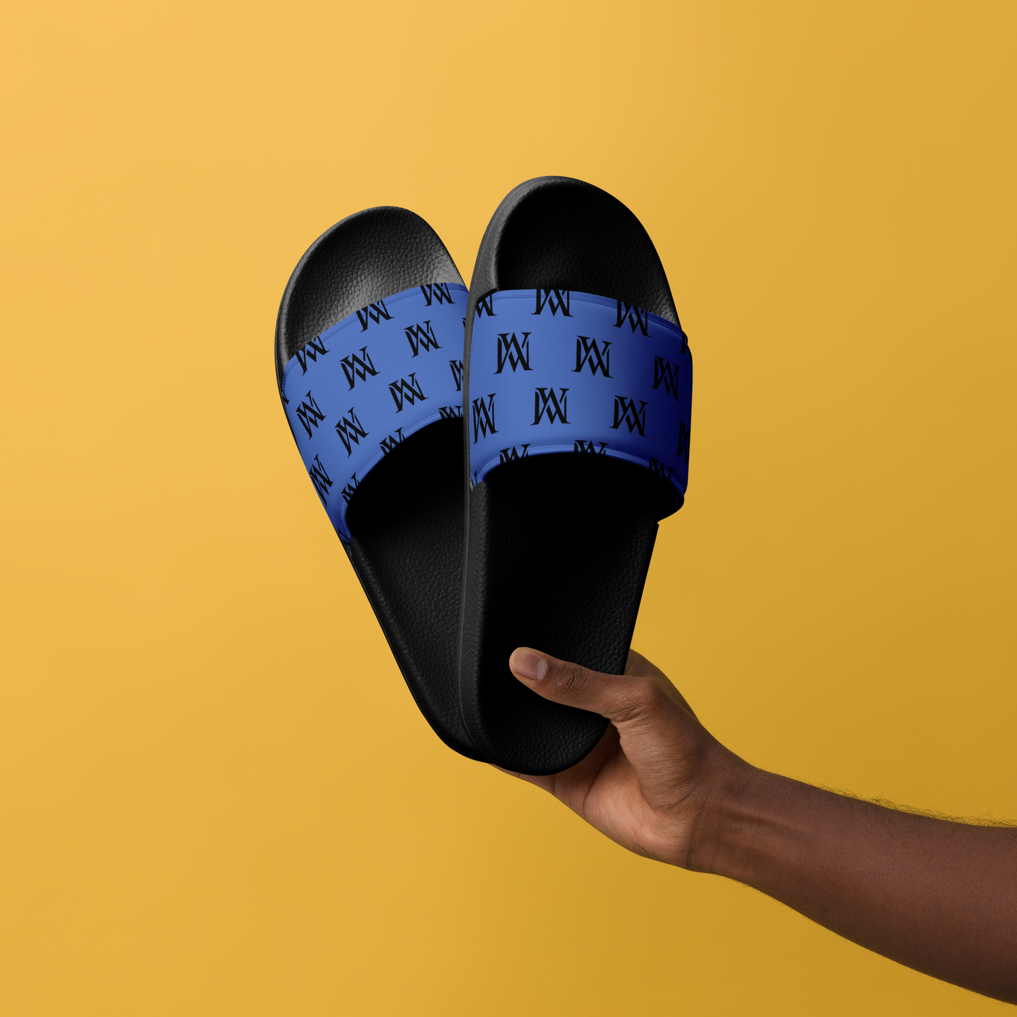 Hand holding black slides with blue straps