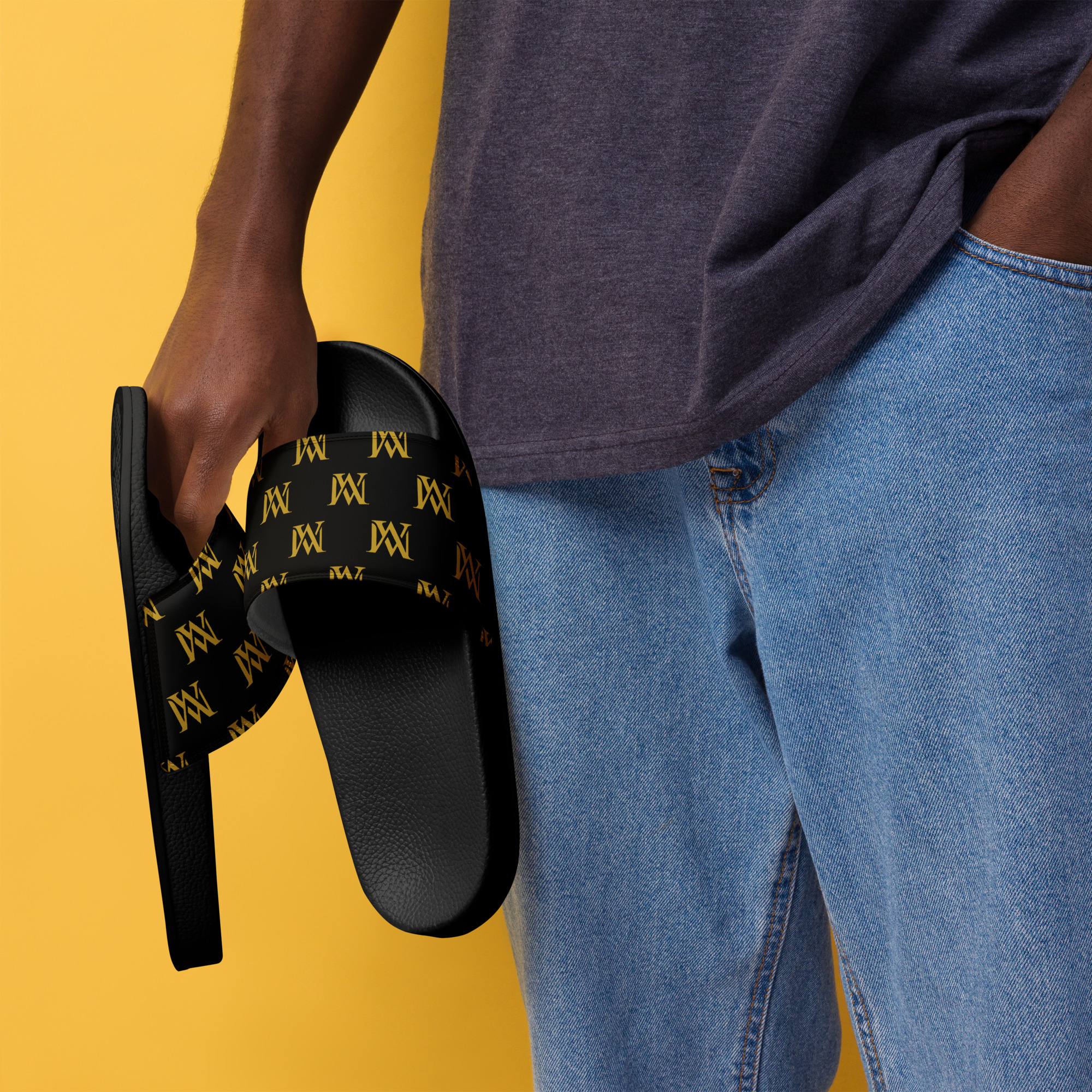 Hand holding black logo slides against yellow background