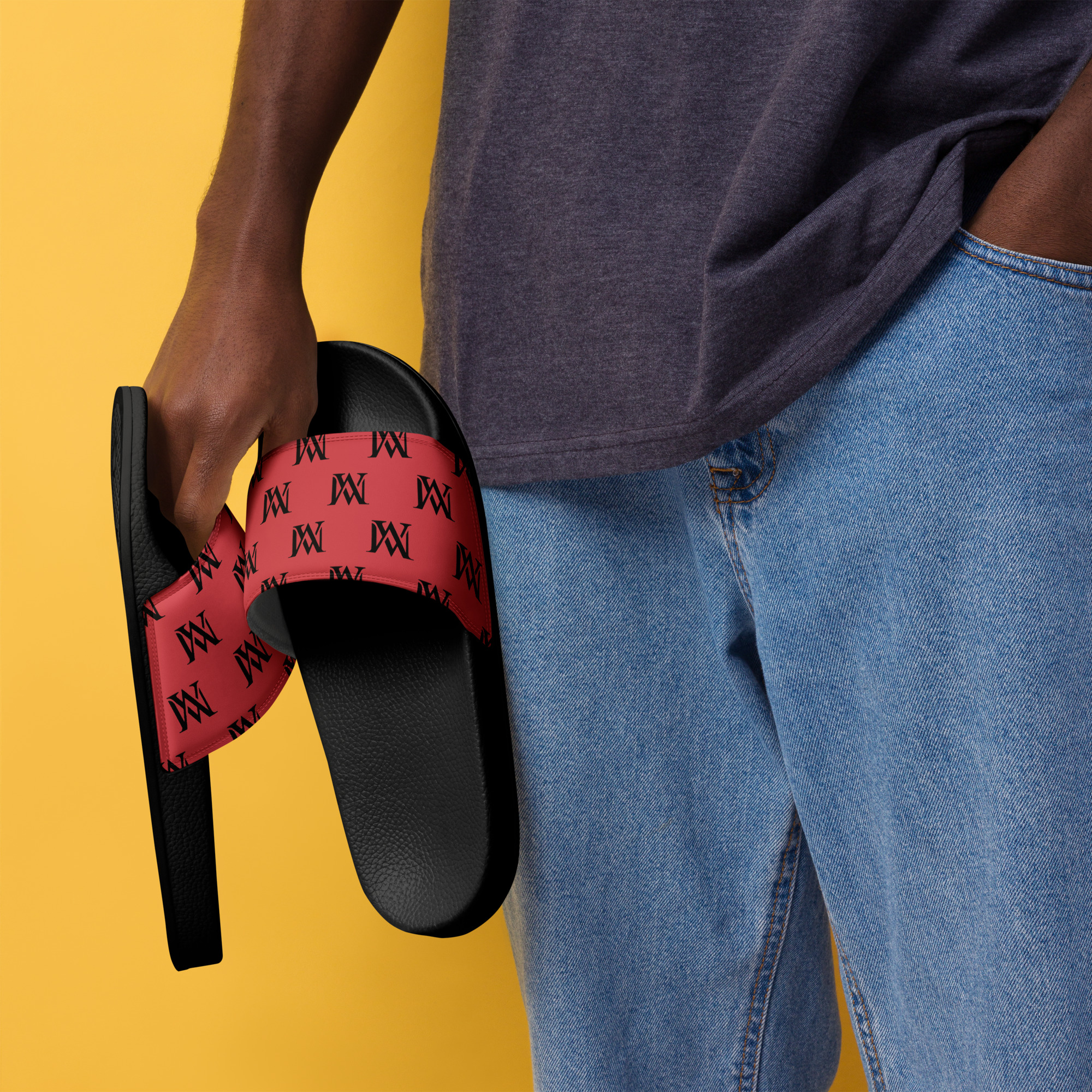 Hand holding red patterned slide sandals