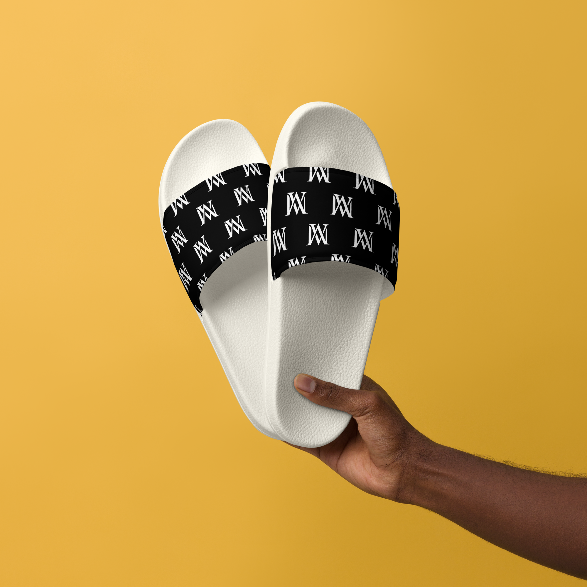 Hand holding white slides with black monogram