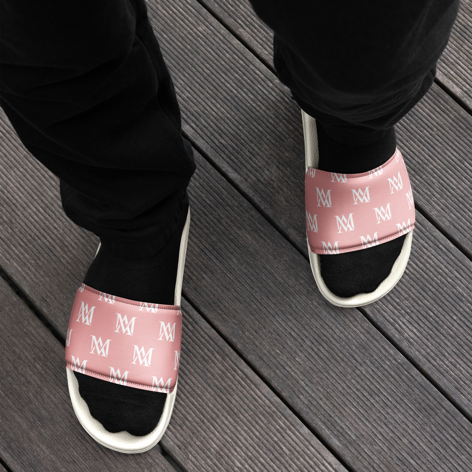 Pink monogram slide sandals worn with black socks