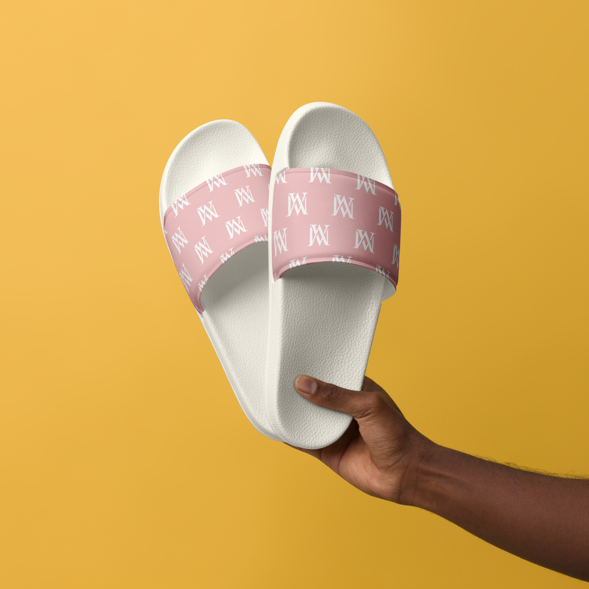 Hand holding white slides with pink straps